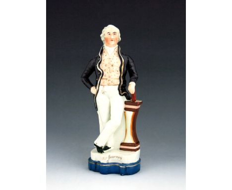 A Staffordshire figure of Joseph John Gurney, circa 1850, modelled standing at a plinth, wearing a black coat and a gilt-deco