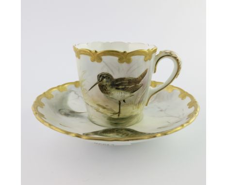 A Worcester Royal China Works painted cabinet cup and saucer, decorated with pheasants and snipe in landscapes, within gilt C