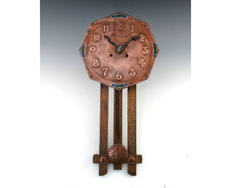 An Arts and Crafts copper and enamelled wall clock, circa 1900, the octagonal dial repousse embossed with Arabic numerals, se