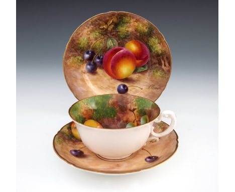Freeman et al for Royal Worcester, a fruit painted tea trio, circa 1949 to 55, including cup, saucer and plate, decorated wit