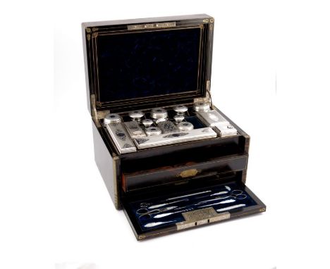 A late Victorian coromandel dressing case, circa 1870, brass bound and strung with a central vacant cartouche with bright cut
