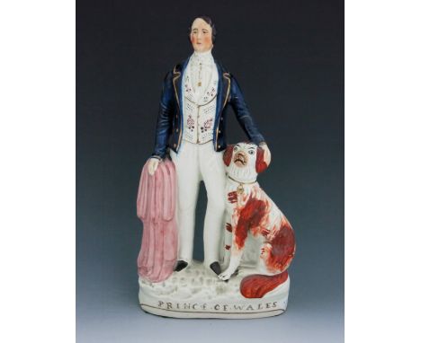 A Staffordshire figure of King Edward VII as the ‘Prince of Wales’, circa 1862, modelled standing with an iron red and white 