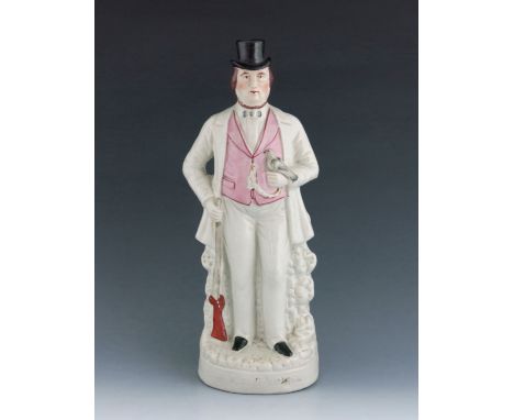 A Staffordshire figure of Arthur Orton, titled 'Sir R Tichborne', circa 1874, modelled standing with a bird in his left hand 