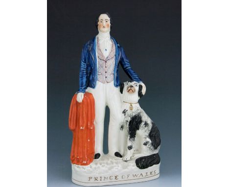 A Staffordshire figure of King Edward VII as the ‘Prince of Wales’, circa 1862, modelled standing with a black and white dog 