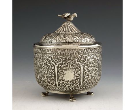 An Indian Kutch silver box and cover, or tea caddy, 19th century, rounded bowl form, repousse embossed and chased with ogee a