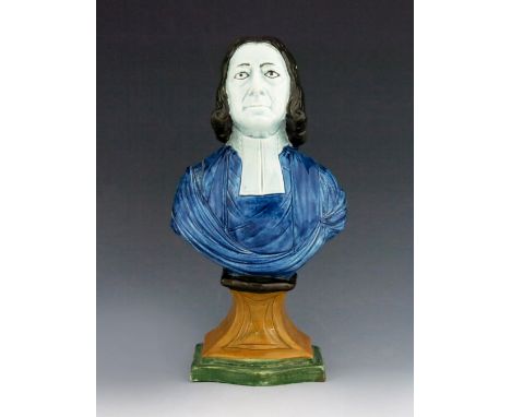 A Staffordshire pottery bust of John Wesley, circa 1825, polychrome enamel painted, on a pedestal base, 31cm high.