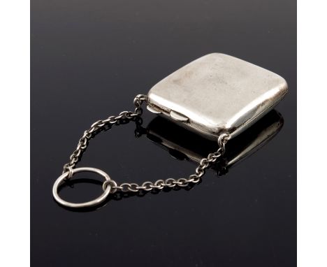 A George V silver compact purse, Mappin and Webb, Birmingham 1917, plain cushioned rectangular form, suspended on two chains 