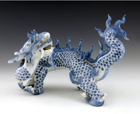 A Japanese Hirado porcelain figure of a dragon, Meiji period, 1868-1912, blue scales, four claws, modelled roaming, 16cm high