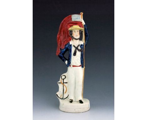 A double sided Staffordshire Crimean War figure, circa, modelled as a soldier and a sailor, standing beside cannonballs and a