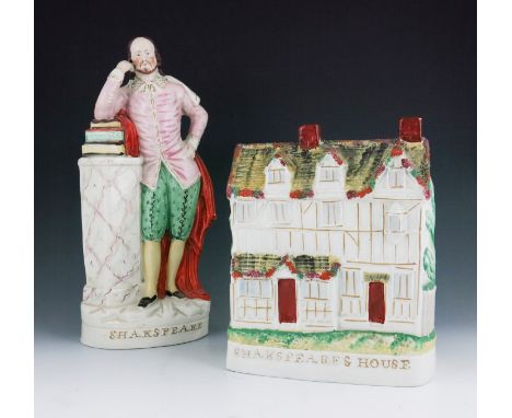 A Staffordshire figure of 'Shakespeare', circa 1870, modelled standing at a column topped by books on which his right elbow r