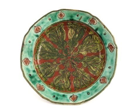 Annie Davis for Della Robbia, an art pottery plate, circa 1900, slip and sgraffito decorated with radiating leaves within an 