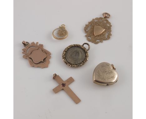 A collection of 9ct yellow gold and gold metal pendants, to include two armorial medallions, gem set cross, a turquoise and s