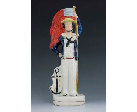 A double sided Staffordshire Crimean War figure, circa, modelled as a soldier and a sailor, standing beside cannonballs and a