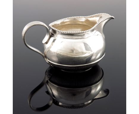 A Victorian silver jug, Stephen Smith and Son, London 1877, squat ovoid and reeded form with beaded rim and fluted acanthus s