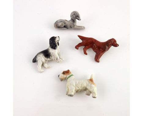 Four Royal Worcester dog brooches, 1932, relief moulded and modelled as a Cocker Spaniel, Setter, Bedlington Terrier and Terr