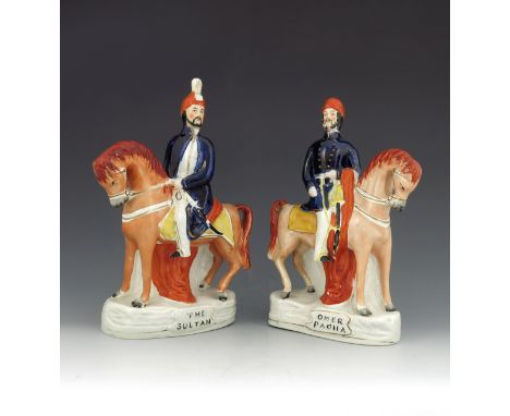 A pair of Staffordshire figures titled 'The Sultan' and 'Omer Pacha', circa 1860, modelled on horseback, polychrome enamel pa