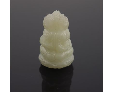 A Chinese pale jade netsuke, carved in the form of a trio of seated buddhas, 3cm high