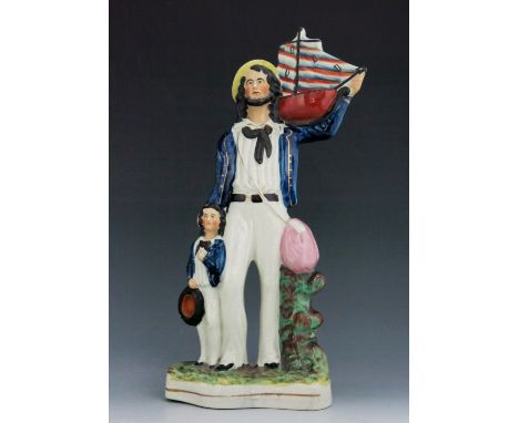 A Staffordshire figure of a ‘Sailor’, circa 1855, modelled standing with a boy to his right, holding a ship with stripe paint