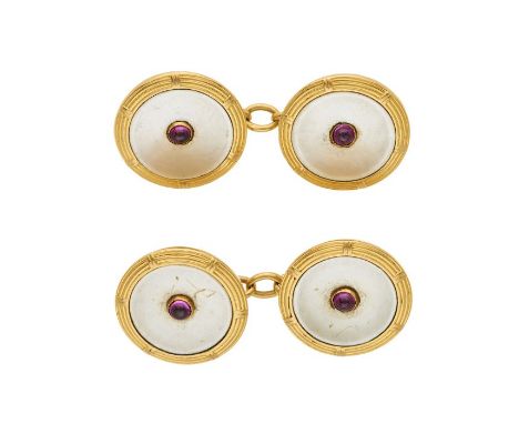 A pair of mid 20th century gold, mother-of-pearl cufflinks, with central pink sapphire cabochon highlight and connecting chai