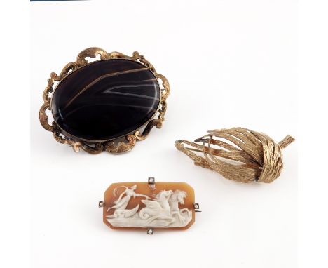 Three decorative brooches to include a 19th Century brown agate cabochon brooch, in gold metal mount with pierced scroll bord