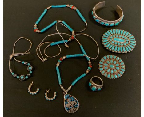 An S A Pinto Navajo turquoise and silver dress ring;  similar unmarked silver coloured metal oval slide brooch; pin brooch;  