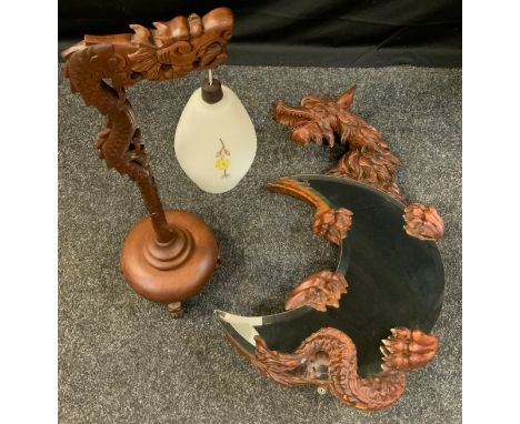 A Chinese Dragon mirror, carved holding a crescent moon plate, 83cm high, 50cm wide;  similar table lamp (2) 