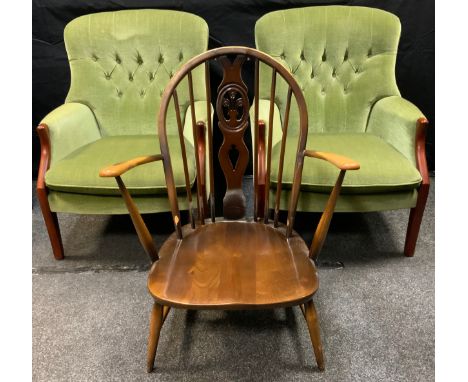 An Ercol Windsor arm chair;  a pair of Parker Knoll button back arm chairs (3) 