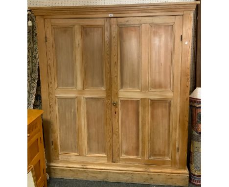 A late 19th/early 20th century pine house keepers cupboard, two panelled doors, enclosing three shelf interior, 184cm high, 1