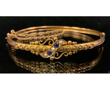 A 9ct gold seed pearl and blue sapphire hinge bangle, stamped 9ct, 5.4g gross 