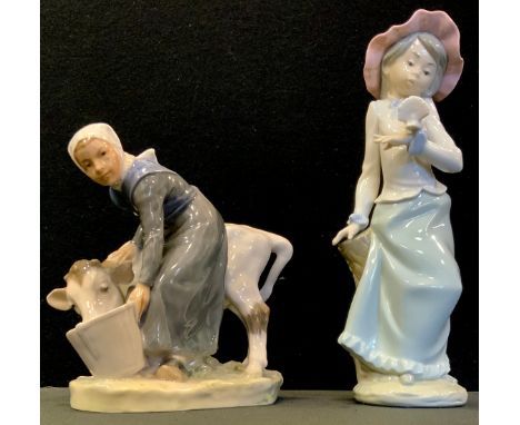A Royal Copenhagen figure Farmer with Cow,  779, printed marks;  Nao Girl with Dove (2) 