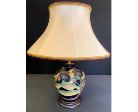 A Moorcroft Western Isles pattern compressed ovoid table lamp, designed by Sian Leaper, wooden base, shade, 43cm overall 