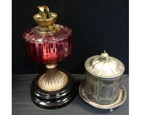 An EPBM biscuit barrel and cover, c.1880;  a Victorian cranberry and gilt metal oil lamp, c.1870 (2) 