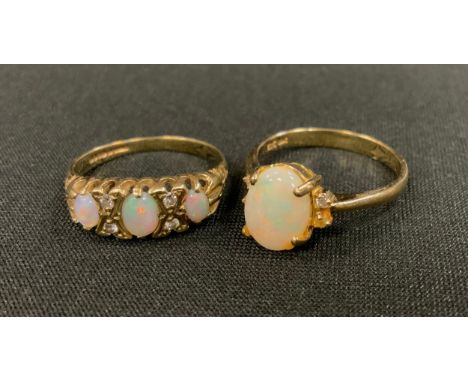 A diamond and opal ring, 9ct gold shank, size L, 1.8g gross;  an oval opal cabochon ring, gold coloured metal shank, stamped 