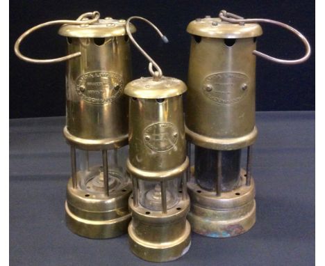 A pair of Lamp &amp; Limelight Company miners lamps;  another smaller (3) 