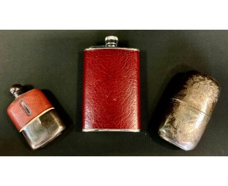 An Edwardian silver plated hip flask, pull cup cover, chased floral decoration, PA &amp; SS; others leather and glass etc (3)