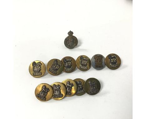 A collection of Kings Own Scottish Borderers brass buttons, each with a lion above a crown and K.O.S.B. six larger buttons (d