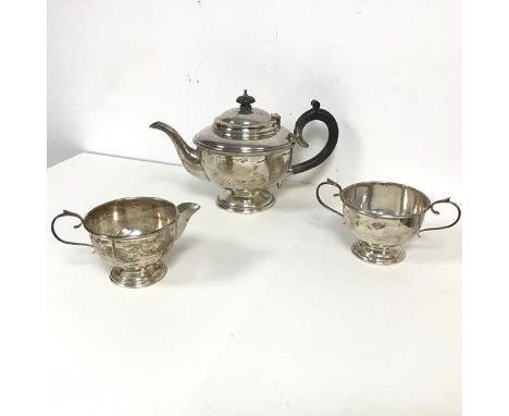 A 1930 Birmingham silver three piece tea service comprising teapot (h.16cm x 26cm) (238.48g), with milk jug and sugar bowl (c