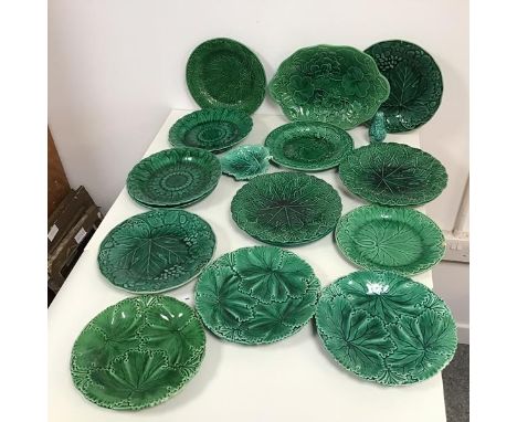 An assortment of green majolica plates with foliate decoration, some marked Wedgwood, two marked Copeland and a leaf shaped t