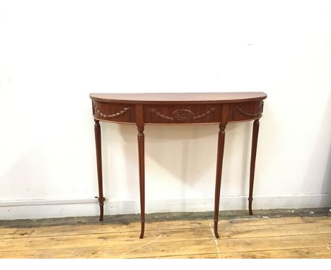 A narrow Adam style console table, with reeded edge over a Neoclassical decorated frieze, with four tapering supports termina