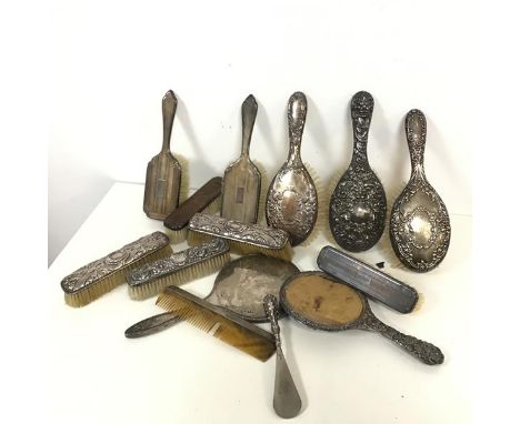 A collection of mostly silver Edwardian dressing table brushes, mirrors and a comb, various patterns and a shoe horn (largest