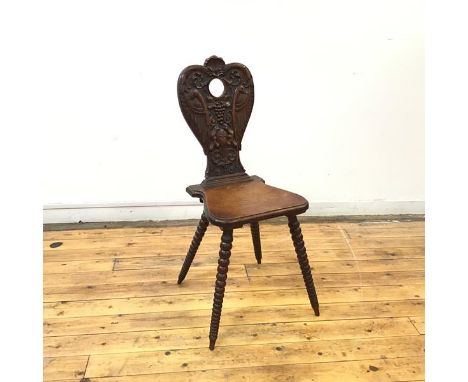 A late 19thc hall chair, the cartouche shaped back incorporating a pair of interlacing birds, with scallop shell crest and fr