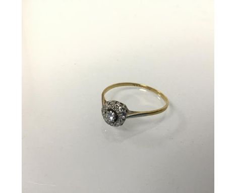 An 18ct gold and platinum mounted diamond set cluster ring (1.73g) (R/S)