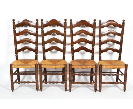 A set of four oak and rush ladder back dining chairs, each with turned uprights and stretchers, 110 cm high (4)