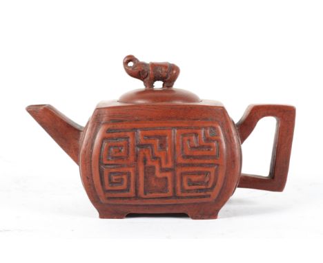 A Chinese Yixing red stone ware style teapot and cover, of rectangular section, with elephant finial, seal mark to base, leng