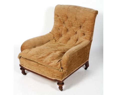 A Victorian Howard and Son style button back armchair, with scrolled arms and turned front legs, 87cm high