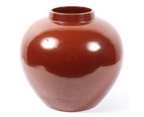 A large red glazed ceramic vase of globular form, height 37cm