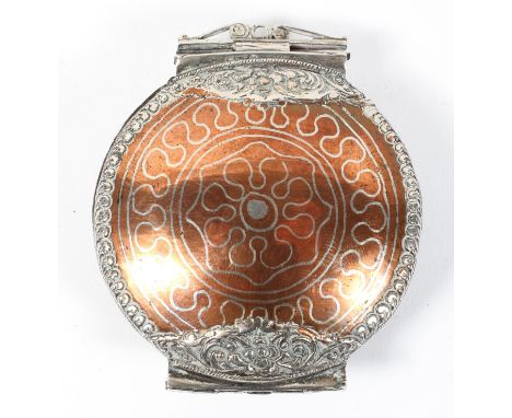 A late 17th/early 18th Century copper and steel hinged opium snuff box, the steel fittings with scrolling foliate work, diame