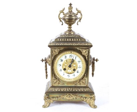 A French gilt brass mantel clock, the 4" ivorine dial with pierced gilt centre, on a brass eight day movement striking to a b