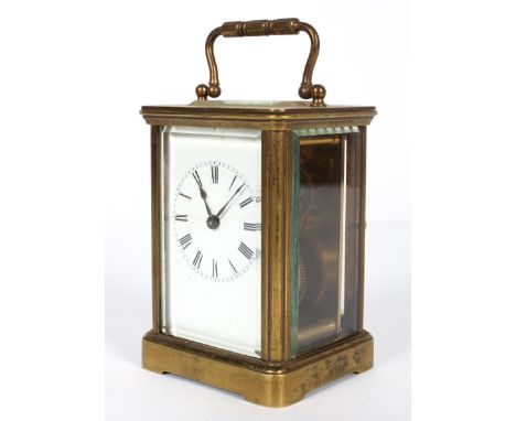 A French brass carriage clock, with white enamelled dial and black Roman numerals, with bevelled glass panelled side and top,