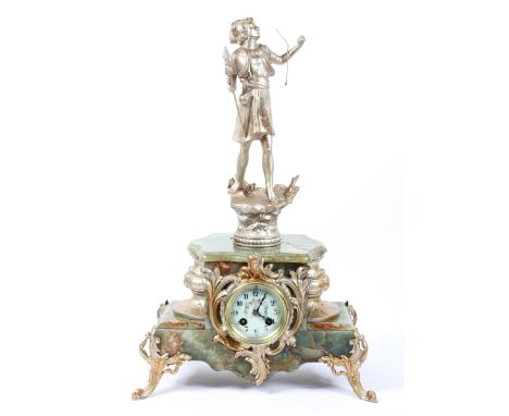 A Continental mantel clock, the 3" ivorine dial on a brass, eight day movement striking to a bell, the onyx case surmounted b